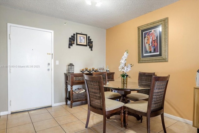 616 NW 26th Ave Unit 210, Miami, FL 33125 - dining area with a textured ceiling and light tile patterned floors