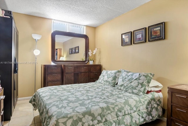 616 NW 26th Ave Unit 210, Miami, FL 33125 - bedroom featuring a textured ceiling and light tile patterned floors