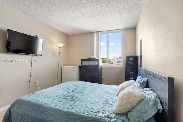 616 NW 26th Ave Unit 210, Miami, FL 33125 - bedroom featuring a textured ceiling and baseboards