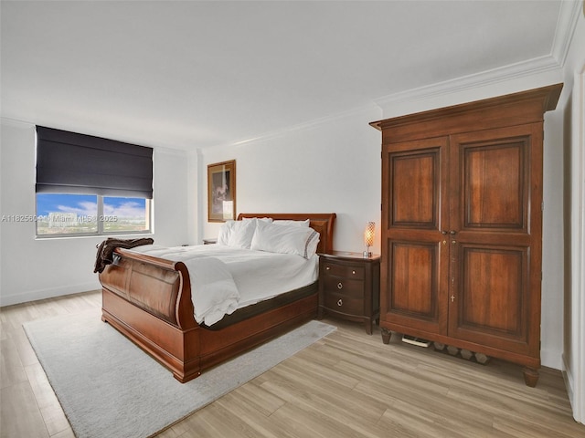 1470 NE 123rd St Unit Aph9, North Miami, FL 33161 - bedroom with light wood finished floors and ornamental molding