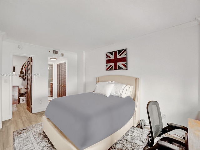 1470 NE 123rd St Unit Aph9, North Miami, FL 33161 - bedroom with wood finished floors, a closet, and crown molding
