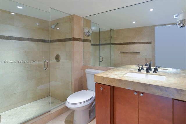 1670 Bay Rd Unit 2D, Miami Beach, FL 33139 - full bathroom with tile walls, vanity, a stall shower, and recessed lighting