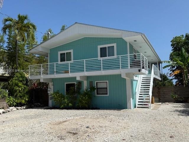 380 Mahogany Dr, Key Largo, FL 33037 - view of front of home featuring stairway, a balcony, and driveway