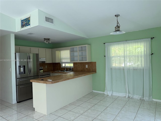 380 Mahogany Dr, Key Largo, FL 33037 - kitchen with stainless steel appliances, a peninsula, exhaust hood, decorative backsplash, and vaulted ceiling