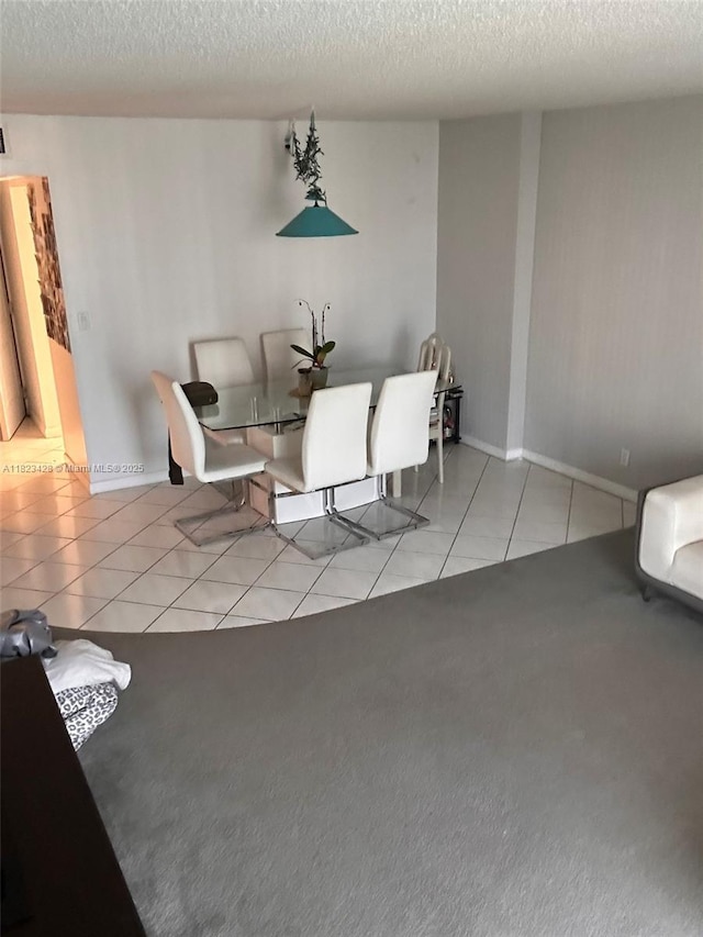 100 Bayview Dr Unit 1030, Sunny Isles Beach, FL 33160 - tiled dining area featuring a textured ceiling and carpet