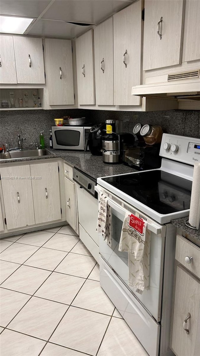 100 Bayview Dr Unit 1030, Sunny Isles Beach, FL 33160 - kitchen with white appliances, custom exhaust hood, tasteful backsplash, and dark countertops
