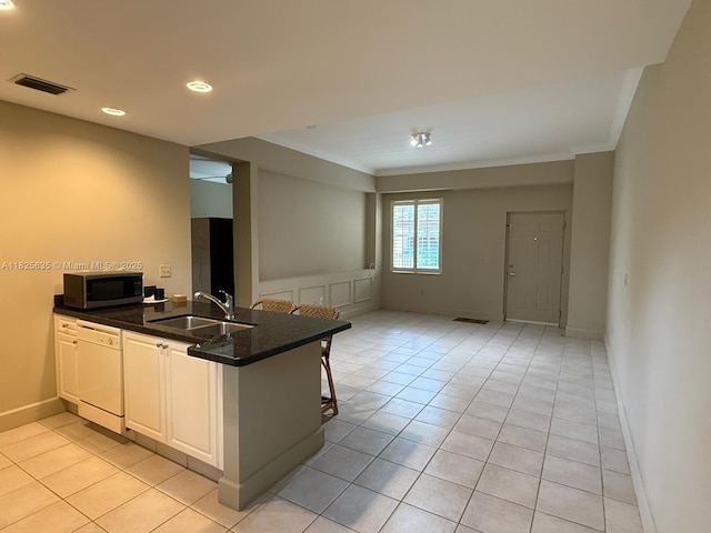 6598 W Sample Rd Unit 6598, Coral Springs, FL 33067 - kitchen featuring white dishwasher, stainless steel microwave, a peninsula, light tile patterned flooring, and crown molding