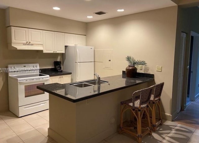 6598 W Sample Rd Unit 6598, Coral Springs, FL 33067 - kitchen featuring white appliances, under cabinet range hood, a peninsula, white cabinetry, and recessed lighting