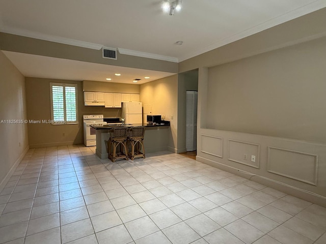 6598 W Sample Rd Unit 6598, Coral Springs, FL 33067 - kitchen featuring white appliances, crown molding, a peninsula, light tile patterned flooring, and dark countertops