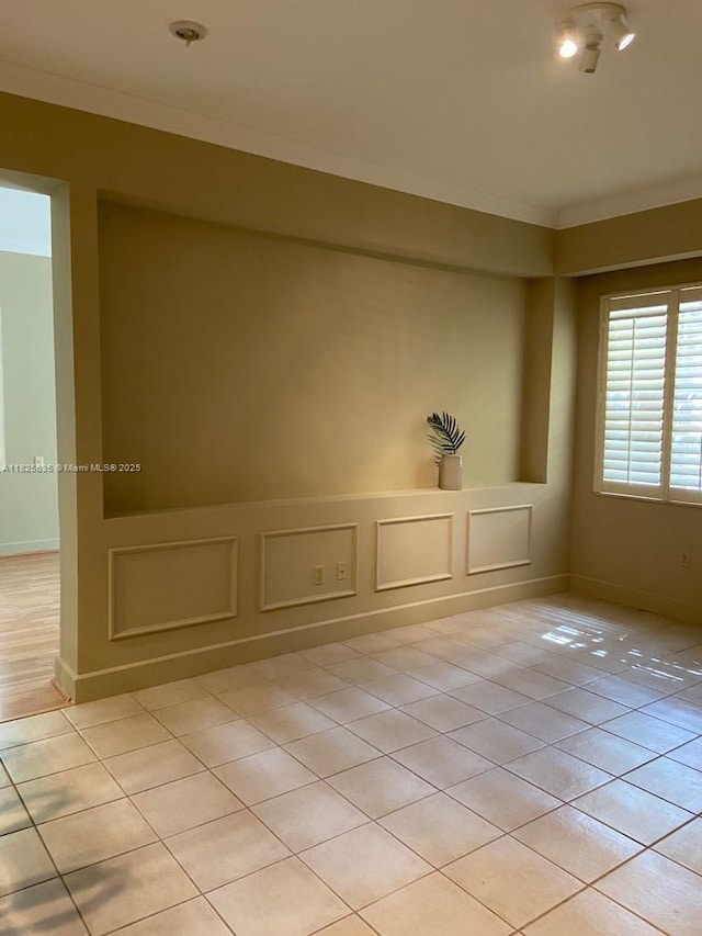 6598 W Sample Rd Unit 6598, Coral Springs, FL 33067 - unfurnished room featuring crown molding, light tile patterned flooring, and a decorative wall