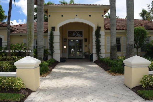 6598 W Sample Rd Unit 6598, Coral Springs, FL 33067 - property entrance featuring french doors, stucco siding, and a tile roof