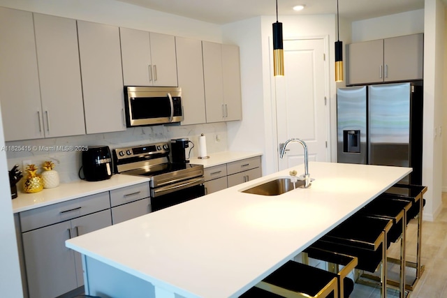 2375 Lancashire St, Davenport, FL 33896 - kitchen featuring stainless steel appliances, gray cabinetry, a kitchen bar, and recessed lighting
