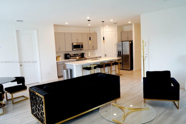 2375 Lancashire St, Davenport, FL 33896 - living room featuring light wood finished floors and recessed lighting