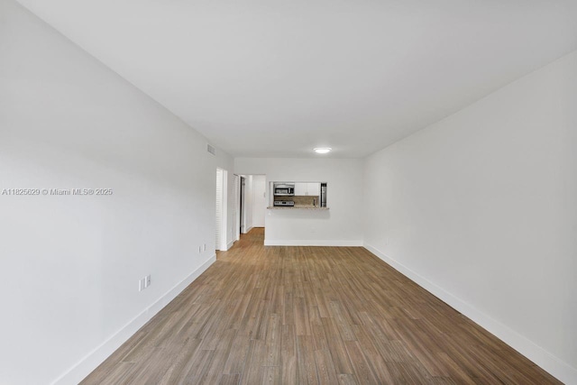 8261 SW 128th St Unit 215, Pinecrest, FL 33156 - unfurnished living room with wood finished floors and baseboards