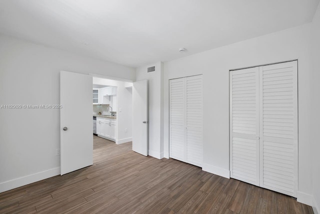 8261 SW 128th St Unit 215, Pinecrest, FL 33156 - unfurnished bedroom featuring two closets and wood finished floors