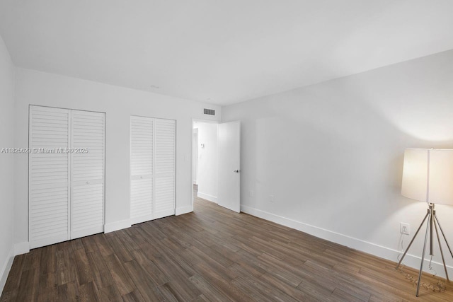 8261 SW 128th St Unit 215, Pinecrest, FL 33156 - unfurnished bedroom with multiple closets and wood finished floors