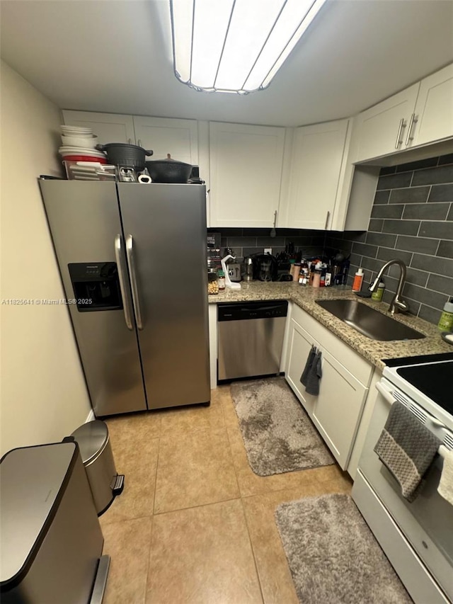 1428 SE 4th Ave Unit 103, Deerfield Beach, FL 33441 - kitchen with stainless steel appliances, white cabinetry, and decorative backsplash