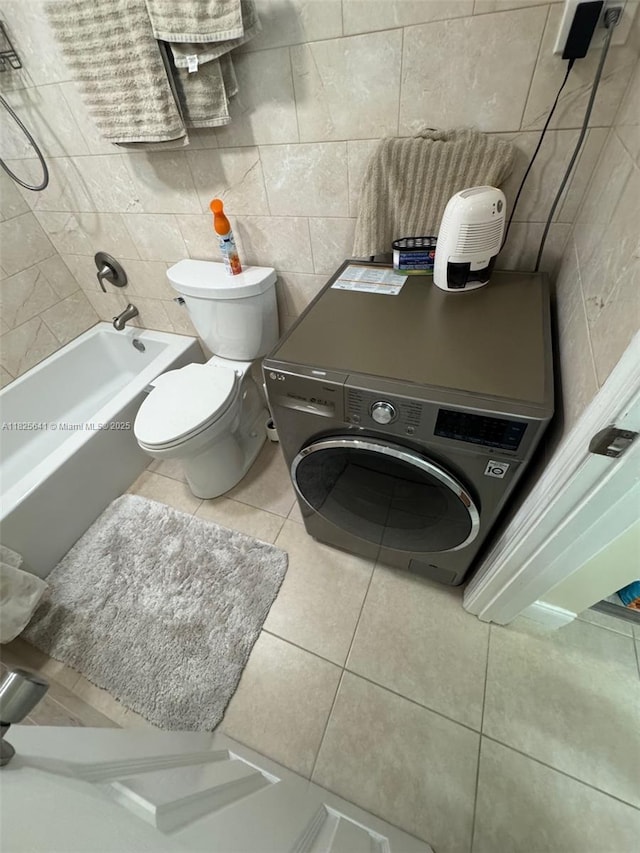 1428 SE 4th Ave Unit 103, Deerfield Beach, FL 33441 - full bath with tile patterned floors, tile walls, and washer / clothes dryer