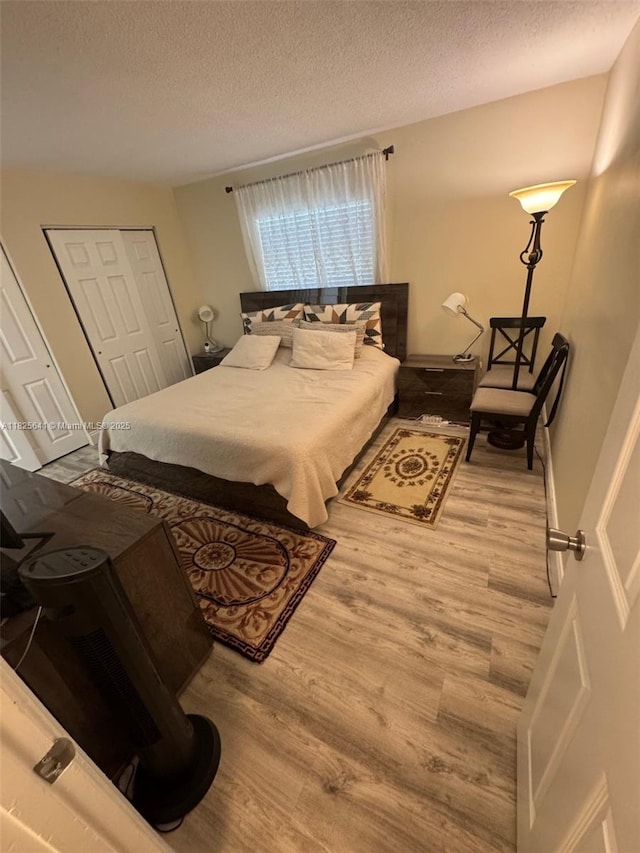 1428 SE 4th Ave Unit 103, Deerfield Beach, FL 33441 - bedroom with a textured ceiling and wood finished floors