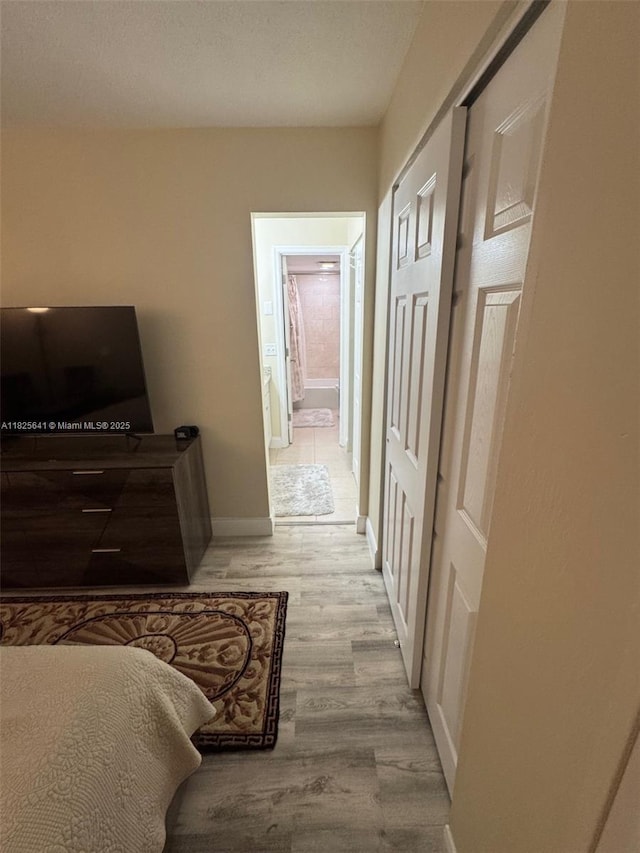 1428 SE 4th Ave Unit 103, Deerfield Beach, FL 33441 - bedroom featuring light wood-style floors, ensuite bath, and a closet