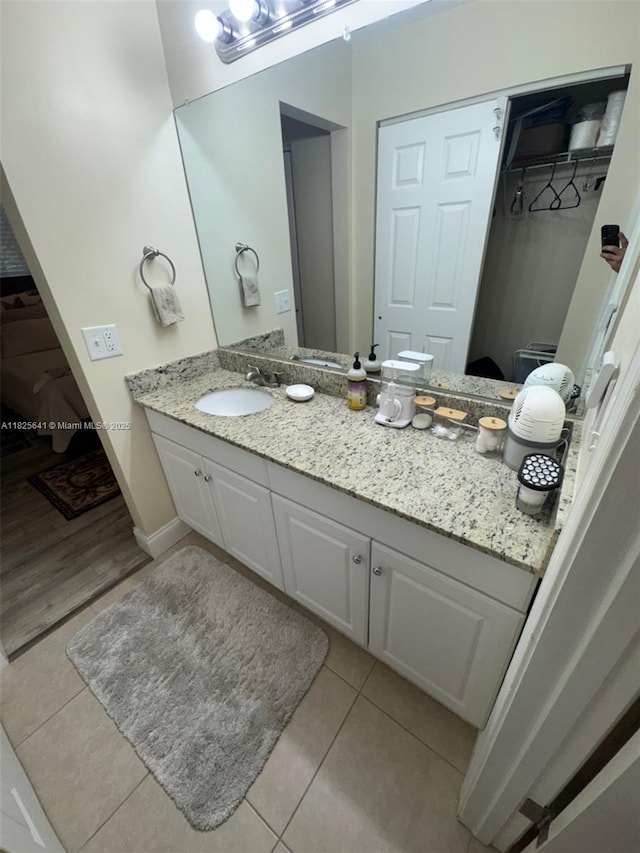 1428 SE 4th Ave Unit 103, Deerfield Beach, FL 33441 - bathroom featuring tile patterned flooring, vanity, and a walk in closet