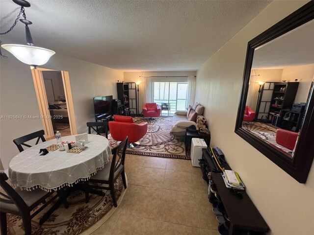 1428 SE 4th Ave Unit 103, Deerfield Beach, FL 33441 - tiled dining area featuring a textured ceiling