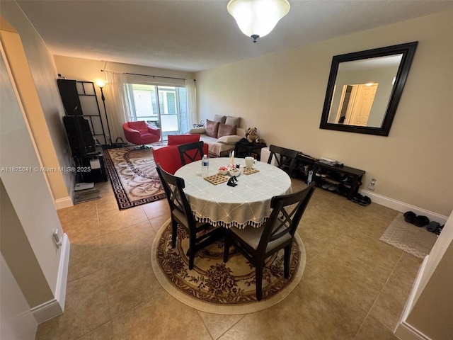 1428 SE 4th Ave Unit 103, Deerfield Beach, FL 33441 - dining area with light tile patterned flooring and baseboards