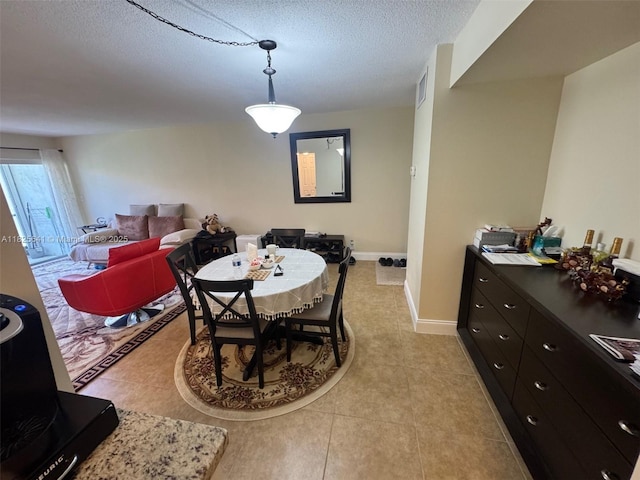 1428 SE 4th Ave Unit 103, Deerfield Beach, FL 33441 - dining space featuring light tile patterned flooring and a textured ceiling