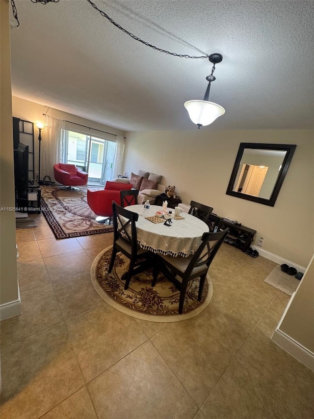 1428 SE 4th Ave Unit 103, Deerfield Beach, FL 33441 - dining room with a textured ceiling and tile patterned flooring