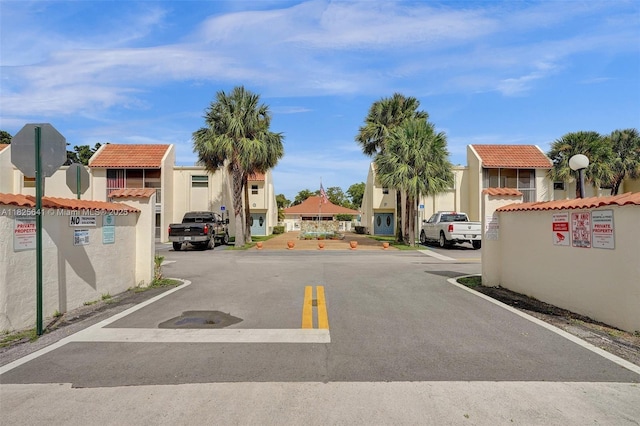 1428 SE 4th Ave Unit 103, Deerfield Beach, FL 33441 - view of asphalt road with a residential view, traffic signs, and street lighting