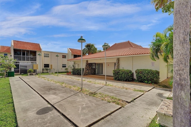 1428 SE 4th Ave Unit 103, Deerfield Beach, FL 33441 - view of front of property with a tile roof and stucco siding