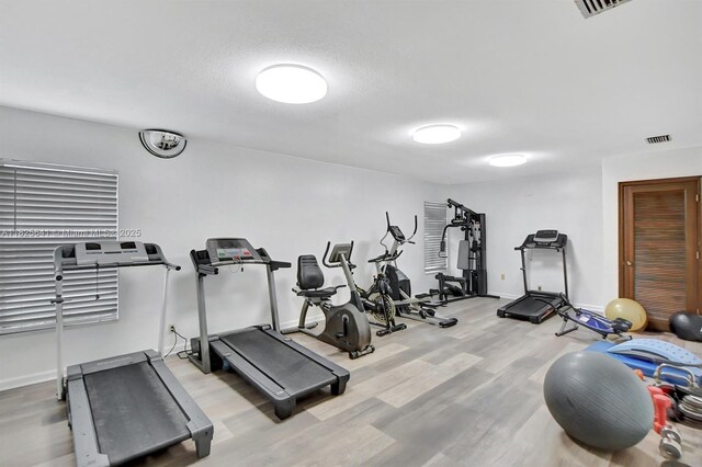 1428 SE 4th Ave Unit 103, Deerfield Beach, FL 33441 - exercise room with wood finished floors and baseboards