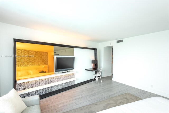 1100 W Ave Unit 506, Miami Beach, FL 33139 - living room with wood tiled floors and baseboards