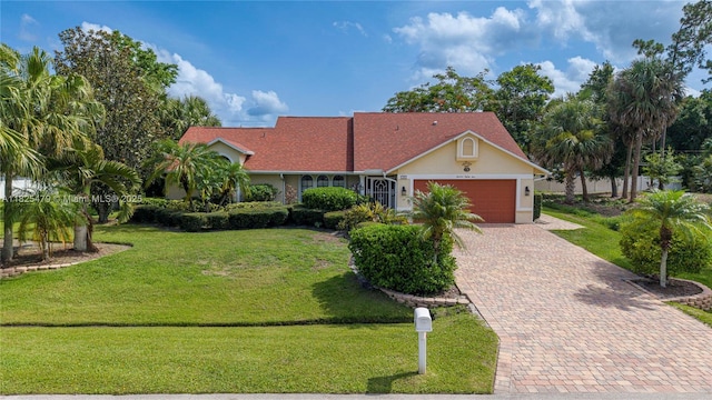1381 SW Leisure Ln, Port St Lucie, FL 34953 - view of front of house with an attached garage, decorative driveway, a front lawn, and stucco siding