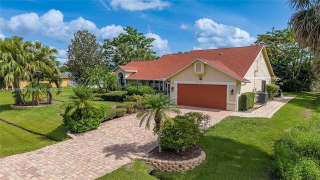 1381 SW Leisure Ln, Port St Lucie, FL 34953 - view of front of house featuring stucco siding, an attached garage, decorative driveway, and a front yard