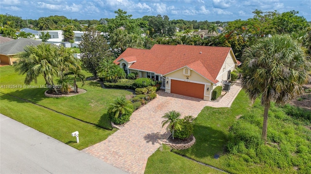 1381 SW Leisure Ln, Port St Lucie, FL 34953 - aerial view of property and surrounding area with a tree filled landscape
