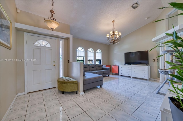 1381 SW Leisure Ln, Port St Lucie, FL 34953 - foyer entrance featuring lofted ceiling, a chandelier, light tile patterned floors, and a textured ceiling