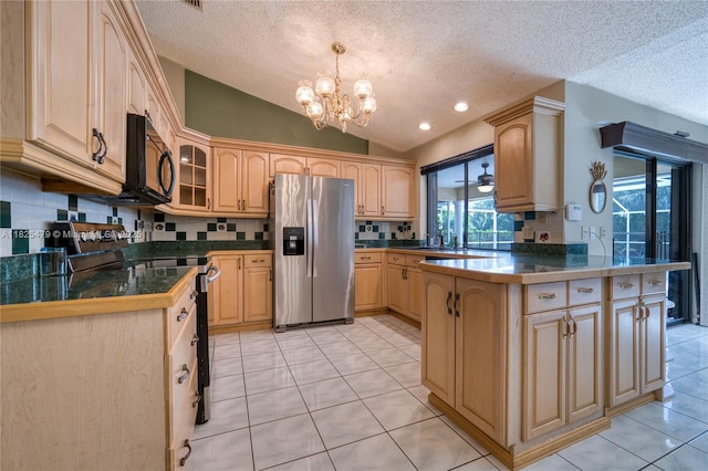 1381 SW Leisure Ln, Port St Lucie, FL 34953 - kitchen featuring black appliances, a peninsula, a textured ceiling, vaulted ceiling, and a chandelier