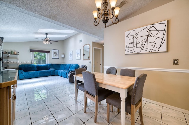 1381 SW Leisure Ln, Port St Lucie, FL 34953 - dining area featuring light tile patterned floors, a textured ceiling, vaulted ceiling, a ceiling fan, and a chandelier