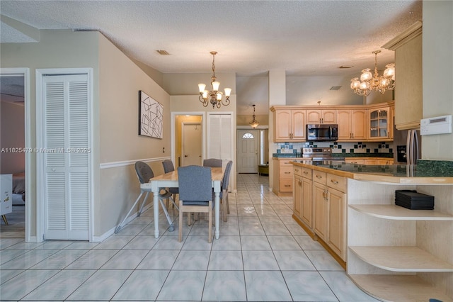 1381 SW Leisure Ln, Port St Lucie, FL 34953 - dining area featuring a chandelier, light tile patterned floors, and a textured ceiling