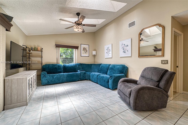 1381 SW Leisure Ln, Port St Lucie, FL 34953 - living area with a ceiling fan, a textured ceiling, lofted ceiling, light tile patterned floors, and a skylight