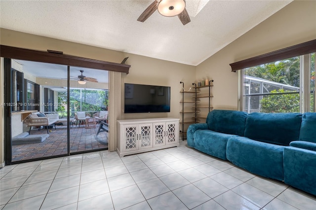 1381 SW Leisure Ln, Port St Lucie, FL 34953 - tiled living room featuring a ceiling fan, vaulted ceiling, and a textured ceiling
