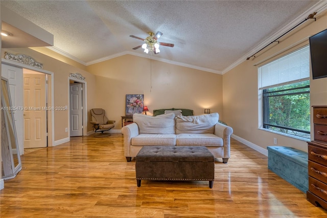 1381 SW Leisure Ln, Port St Lucie, FL 34953 - living room featuring a textured ceiling, vaulted ceiling, a ceiling fan, ornamental molding, and light wood finished floors