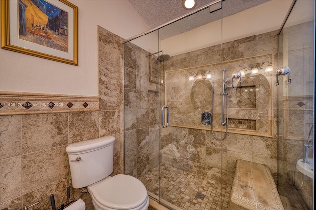 1381 SW Leisure Ln, Port St Lucie, FL 34953 - full bath featuring a shower stall, tile walls, a wainscoted wall, and a textured ceiling
