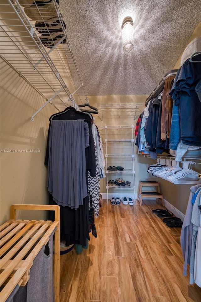 1381 SW Leisure Ln, Port St Lucie, FL 34953 - spacious closet featuring wood finished floors