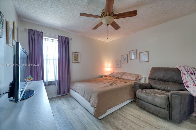 1381 SW Leisure Ln, Port St Lucie, FL 34953 - bedroom with wood finished floors, a textured ceiling, and ceiling fan