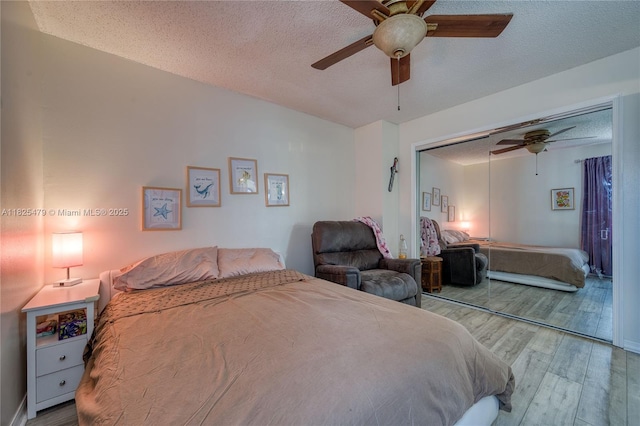 1381 SW Leisure Ln, Port St Lucie, FL 34953 - bedroom featuring wood finished floors, a closet, a textured ceiling, and a ceiling fan