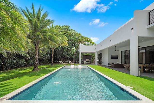 7660 SW 124th St, Pinecrest, FL 33156 - swimming pool with outdoor lounge area, a ceiling fan, a lawn, and a patio