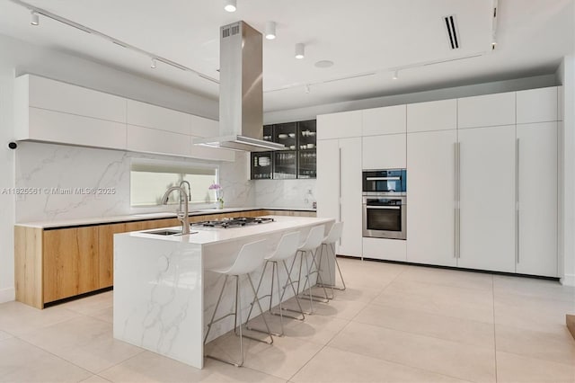 7660 SW 124th St, Pinecrest, FL 33156 - kitchen featuring oven, island exhaust hood, rail lighting, and an island with sink