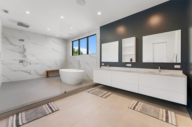 7660 SW 124th St, Pinecrest, FL 33156 - bathroom with double vanity, a freestanding tub, a marble finish shower, recessed lighting, and tile walls